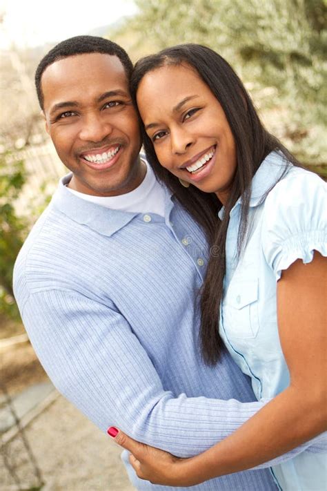 Portrait Of A Happy African American Couple Smiling And Hugging Stock