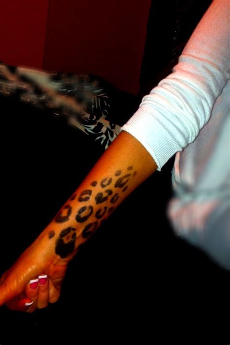 cheetah print arm tattoo
