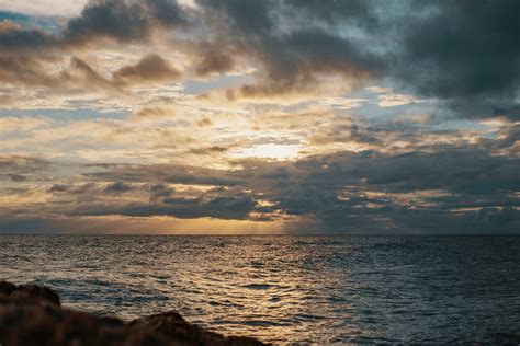 Sea Under Gray Cloudy Sky During Dawn · Free Stock Photo