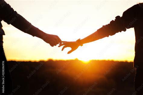 Couple Holding Hands Sunset