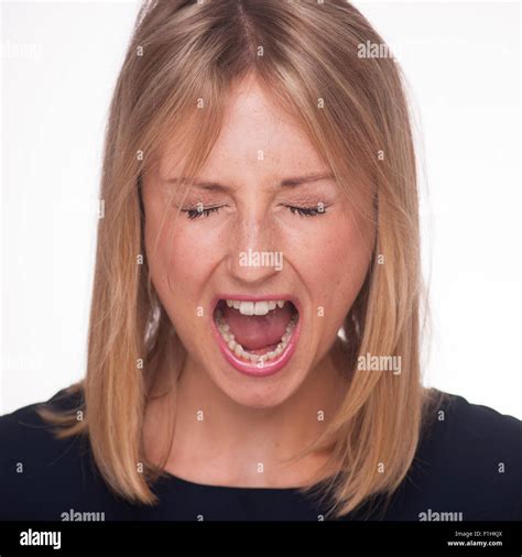 Blonde Woman Yelling With Her Eyes Closed Stock Photo Alamy