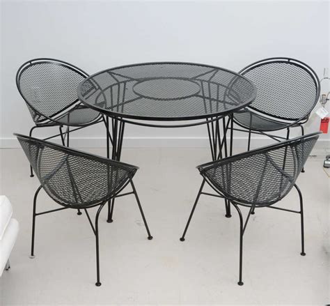 Wrought iron, one of the two forms in which iron is obtained by smelting; Vintage Salterini Wrought Iron Patio Set at 1stdibs
