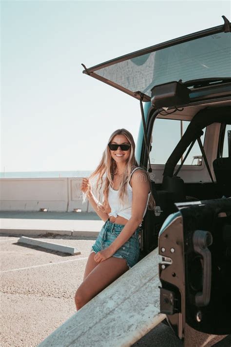 Surfer Girl Sitting At A Car With Surfboard California Lifestyle Stock