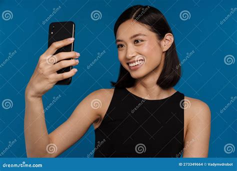 Young Beautiful Smiling Asian Woman Taking Selfie On Her Phone Stock