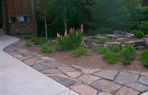 Driveway Landscaping With Flagstone Providing A Walkway That Doubles As