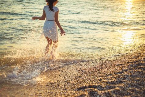 A Woman Runs Around The Sea And Is Happy Stock Photo Image Of Tanned