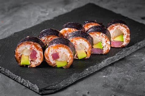 Appetizing Sushi Roll With Tuna Salmon Escolar Crab And Avocado On A