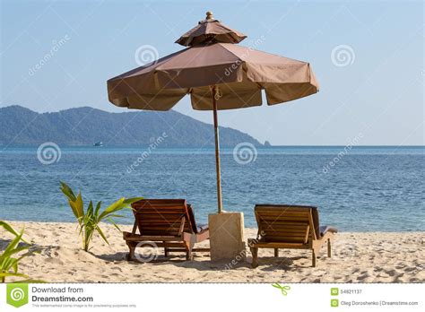 This gazebo features a powder coated steel frame covered with a coated polyester canvas to provide you with the optimal amount of shade and protection from harmful uv and climate conditions. Beach Chair And Umbrella On The Beach In Sunny Day , Thailand Stock Image - Image of beds ...