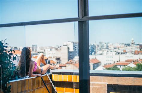 Anonymous Woman Sunbathing On The Rooftop Looking At The City By