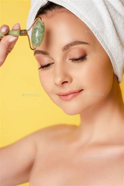 Beautiful Naked Woman With Towel On Head Using Jade Roller Isolated On