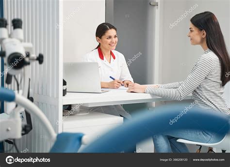 Positive Delighted Young Doctor Consulting Her Patient Stock Photo By