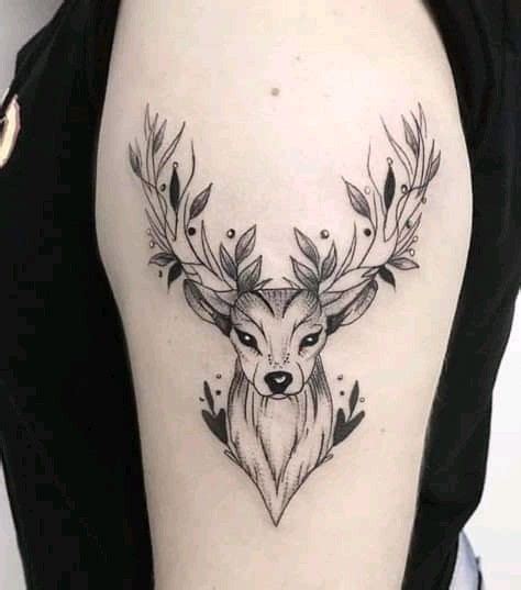 A Womans Arm With A Deer Head And Leaves Tattoo On The Left Side
