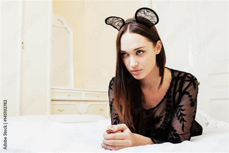 Young Pretty Brunette Woman Wearing Sexy Lace Mouse Ears Laying Stock