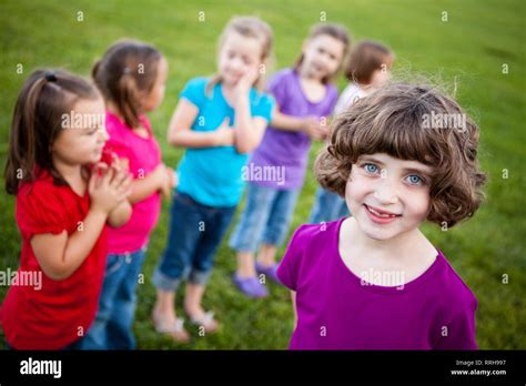 Happy Girl Standing With Friends Outside Stock Photo Alamy
