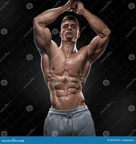 Handsome Muscular Bodybuilder Posing On Front Lat Spread Stock Image