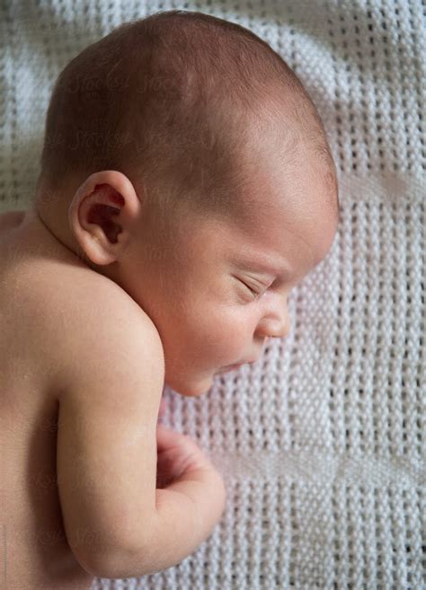 Profile Of A Newborn Baby Sleeping On A Blanket By Stocksy