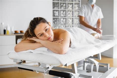 Beautician With Client During Hair Removal Procedure In Workspace Stock