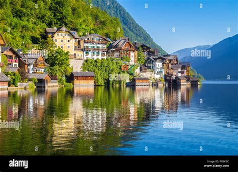 Traditional Old Wooden Houses In Famous Hallstatt Mountain Village At