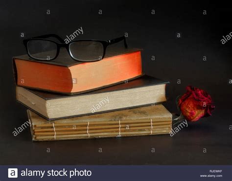Reading Glasses On Top Of Three Old Books Stacked On Top Of Each Other