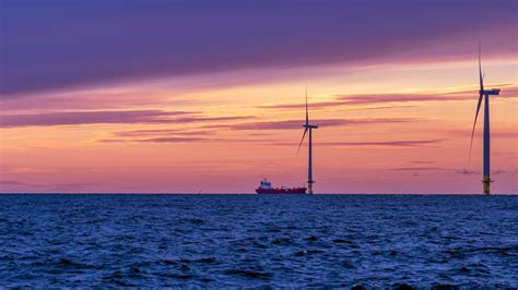 Ship On Bothnian Sea Finland And Wind Turbine During