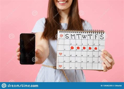 Woman Holding Female Periods Calendar For Checking Menstruation Days