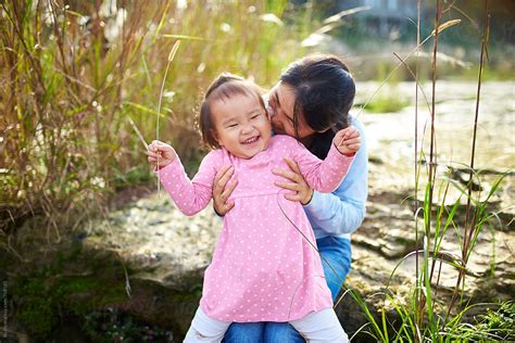 Happy Little Asian Girl Playing With Her Mother Smile In Her Mothers