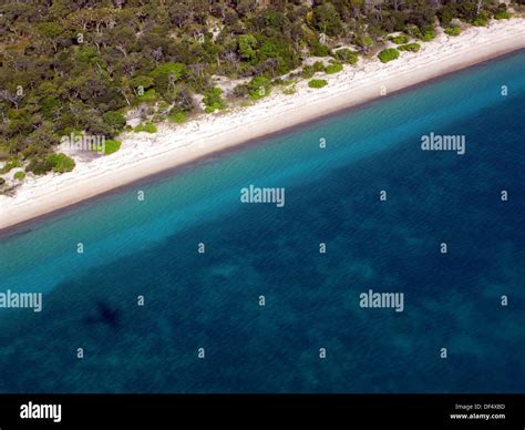 Remote Beach On The Western Coast Of Badu Island With Plane Shadow