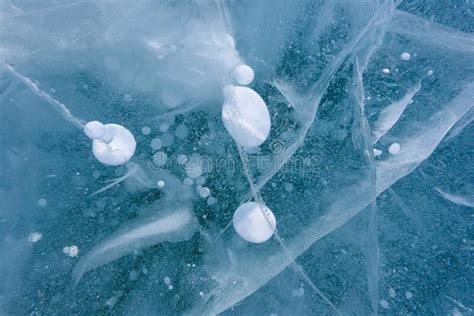 Beautiful Ice Of Lake Baikal With Abstract Cracks And Frozen Air