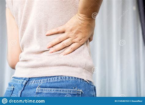 Woman Suffering From Lower Back Pain Hand Holding Right Side Back Pain