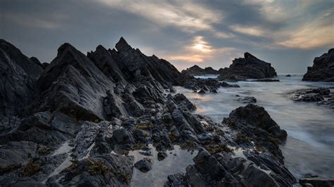 Download Wallpaper 2048x1152 Rocks Sea Sunset Coast Landscape