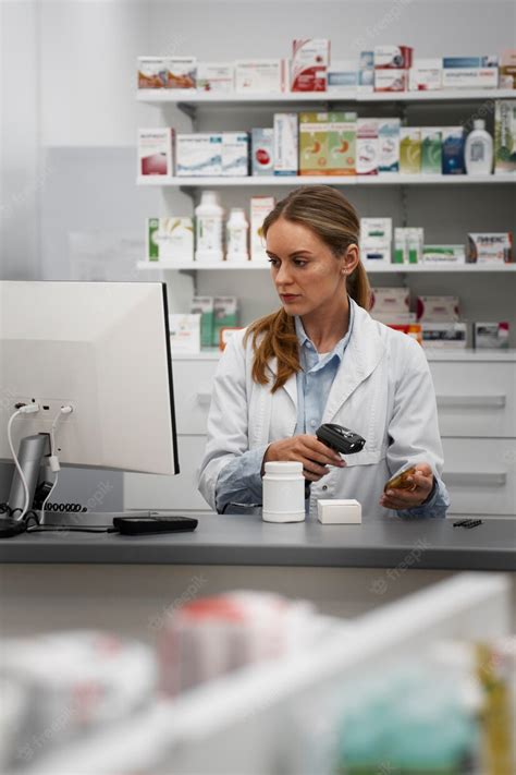 Free Photo Female Pharmacist Scanning Medicine At The Counter
