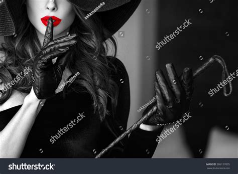 Sexy Dominant Woman In Hat And Whip Showing No Talk Closeup Bdsm Selective Black And White