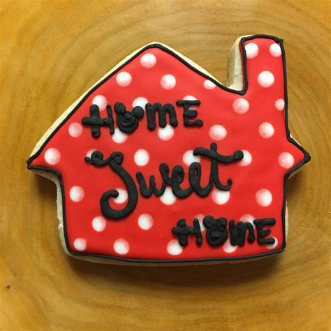 A Decorated Cookie With The Words Home Sweet Home On Its Front And Side
