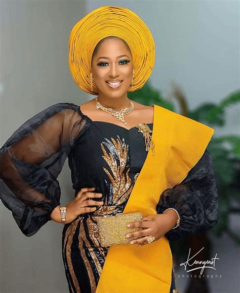 Clipkulture Yoruba Bride In Black And Gold Traditional Dress With Net Sleeves Yellow Gele And