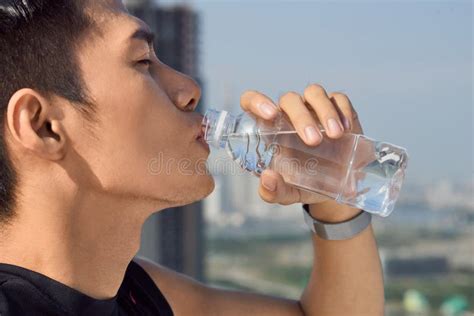 Close Up Of A Man Drinking Water From A Bottle Outside Stock Image
