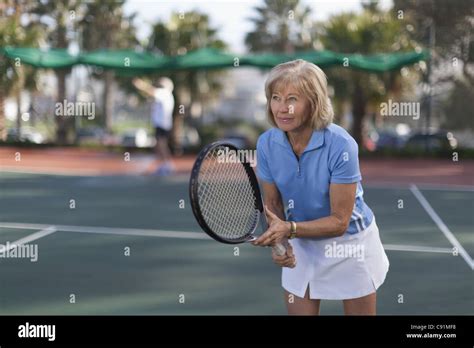 Older Woman Playing Tennis Outdoors Stock Photo Alamy