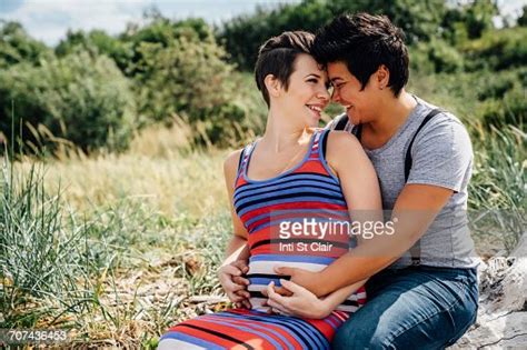 Pregnant Lesbian Couple Rubbing Noses Outdoors Photo Getty Images