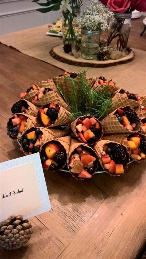Individual fruit cups of grapes, strawberries, melons, blueberries, and red raspberries, served in waffle bowls, made a lovely presentation for my daughter's baby shower. Cute Woodland Baby Shower Ideas For Any Budget - Tulamama