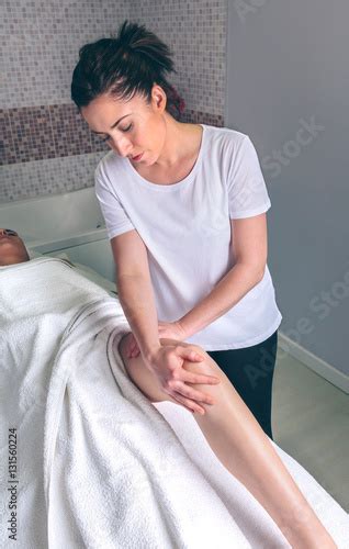 Portrait Of Female Massage Therapist Doing Lymphatic Drainage Massage