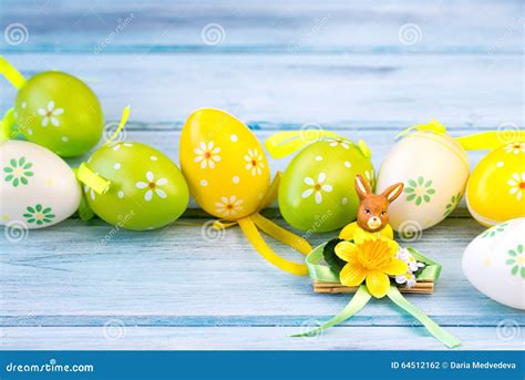 Colorful Easter Eggs And Rabbit Statuette On A Wooden Background Stock