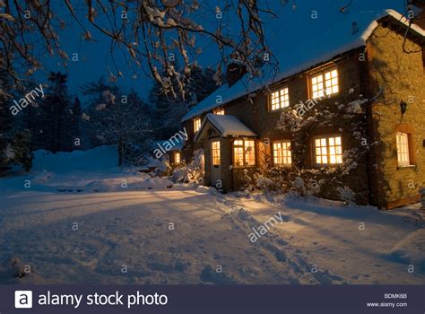 Christmas Scene Of Country Cottage As Night Begins To Fall