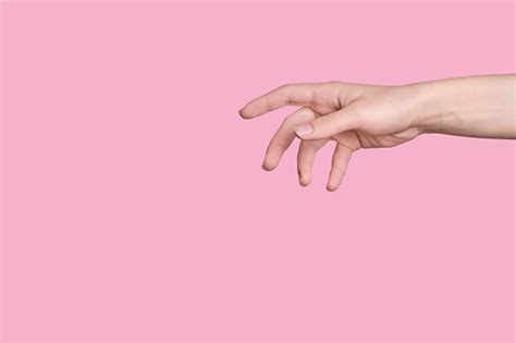 A Caucasian Hand Reaches Out To Help Say Hello Pink Background Stock