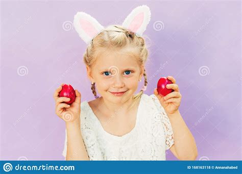 Easter Portrait Of Pretty Little Girl With Colorful Eggs Stock Photo