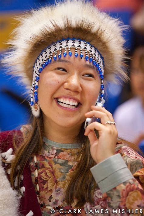 Young Yupik Woman With Tradtional Headdress Talks On Cell Phone At The