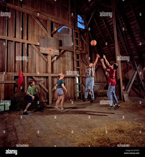 Four Youth Play Basketball Inside A Barn Loft Stock Photo Royalty Free