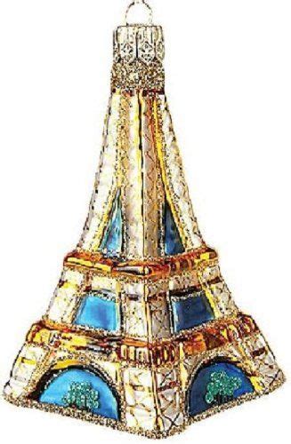 A Glass Ornament With The Eiffel Tower In Blue And Gold Colors