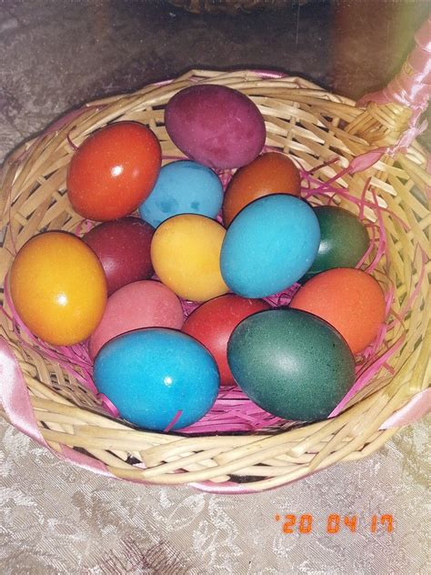 A Basket Filled With Lots Of Colorful Eggs