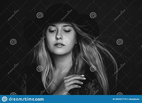 Beautiful Blonde Woman Wearing A Hat Artistic Film Portrait In Black