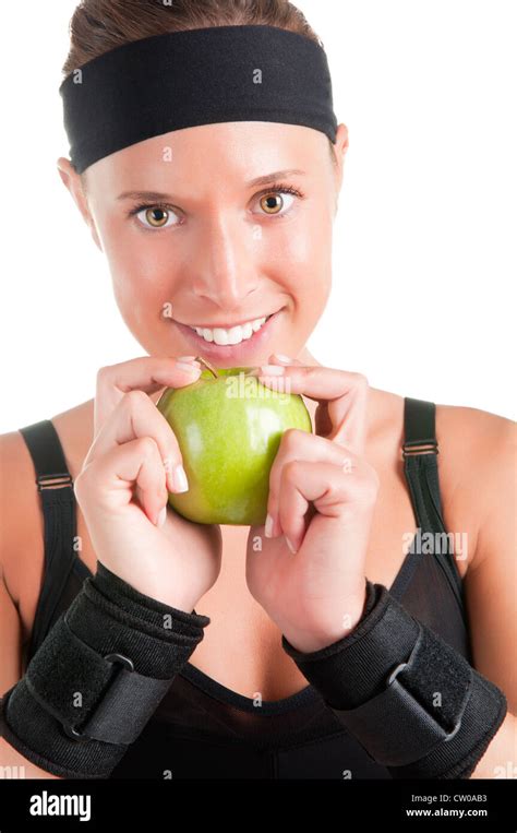 Woman About To Eat A Green Apple After Her Workout At The Gym Stock