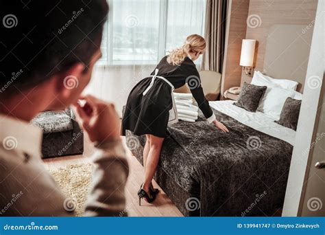 slim hotel maid standing with her back to client of the hotel stock image image of independent